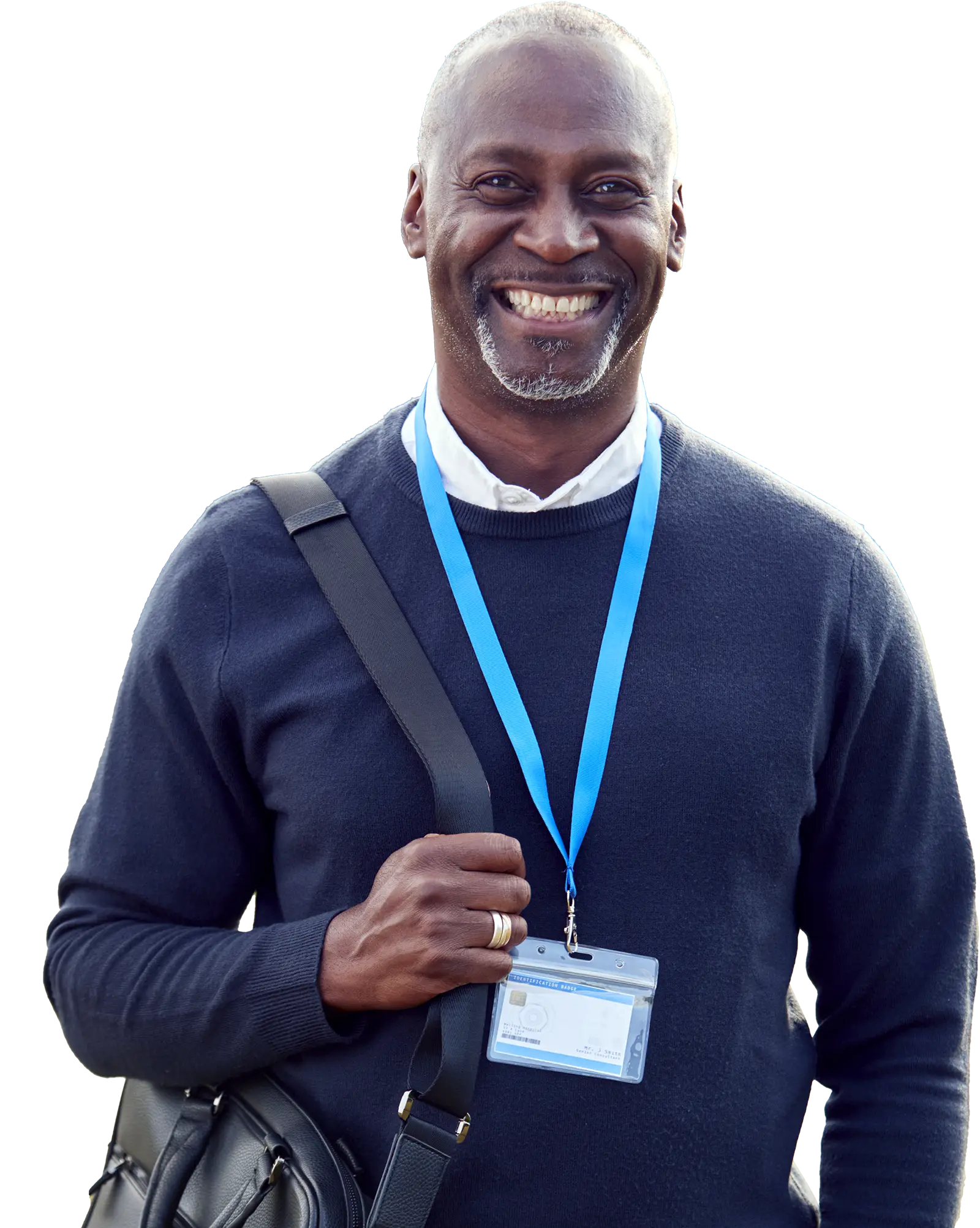 Smiling man with grey hair and lanyard, standing with a bag in Leeds; volunteering event for Doing Good Leeds.