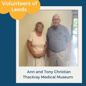 Ann and Tony Christian volunteering together at Thackray Medical Museum, Leeds. Volunteers of Leeds label shown.
