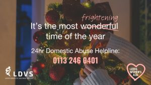 Person decorates Christmas tree; message highlights support for domestic abuse in Leeds, with helpline. Leeds Women’s Aid shown.