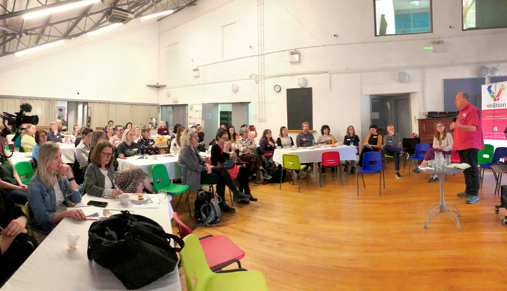 large hall full of people who attended the Transforming mental health grants celebration and learning event